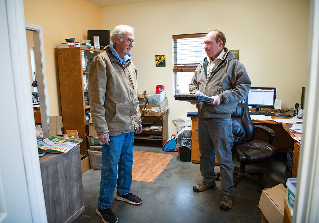 Marcus Wallace consults with his father Mervin about bulk wildflower seed prices